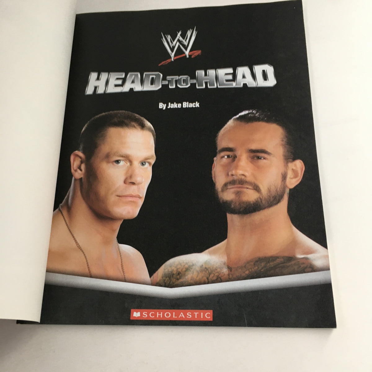 Inside page of WWE WWF Magazine 2012 Head-to-Head showing a matchup between John Cena and CM Punk, authored by Jake Black.