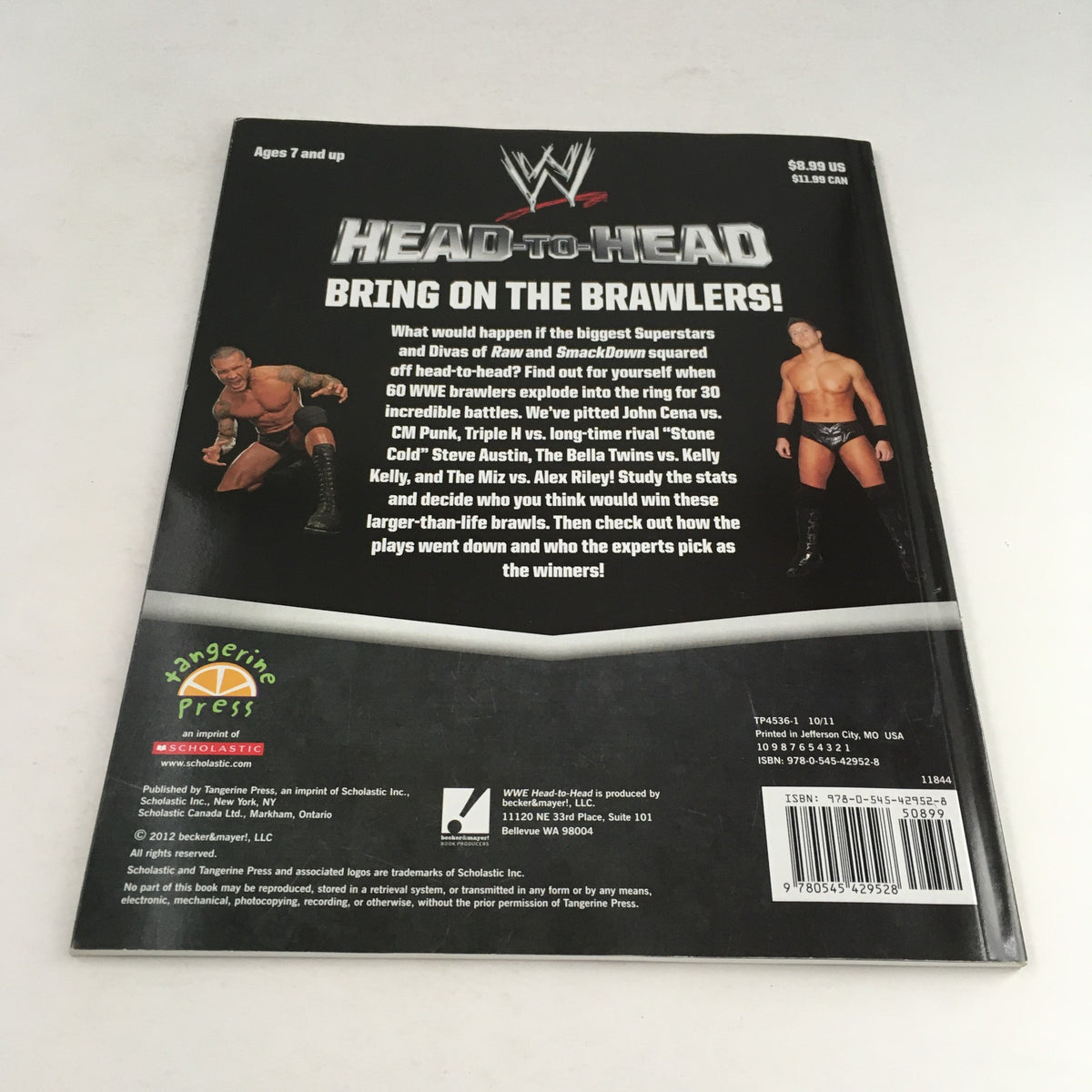 Back cover of WWE WWF Magazine 2012 Head-to-Head, featuring images of prominent wrestlers and a summary of the magazine's content.