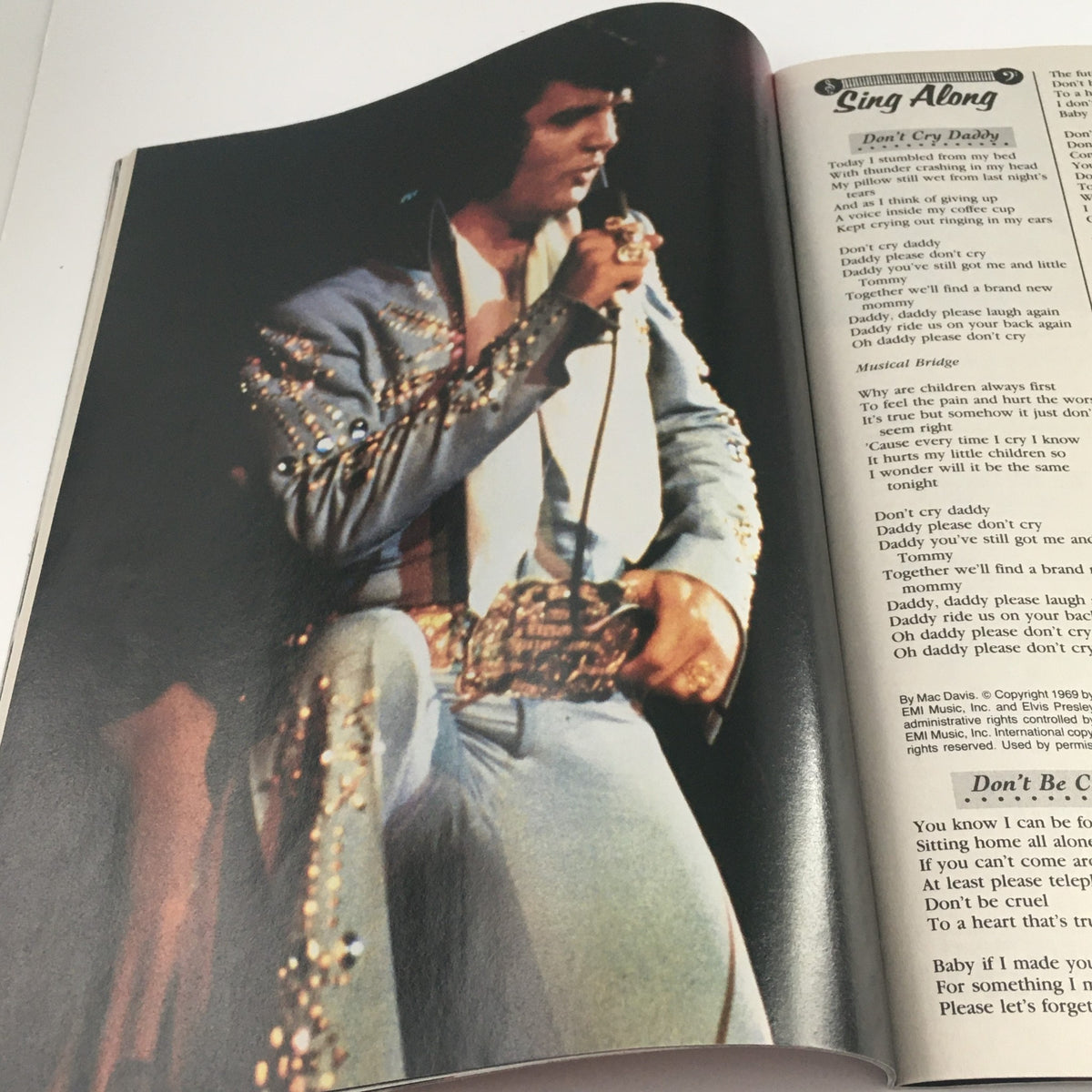 Modern Screen Yearbook #31 Presents Elvis Presley, featuring a dynamic image of Elvis in a flamboyant outfit during a performance, representing his stage presence.