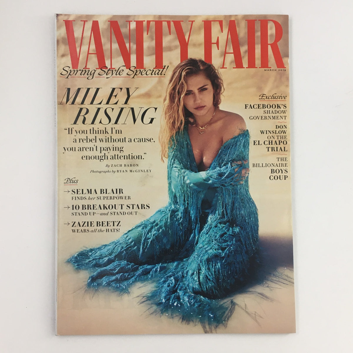Cover of Vanity Fair Magazine March 2019 featuring Miley Cyrus in a stunning blue outfit, promoting the issue with a headline 'Miley Rising'. The cover also highlights Selma Blair and includes articles about spring style and exclusive features.