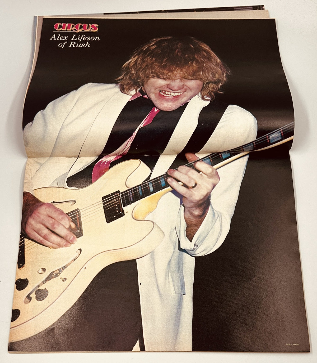 Alex Lifeson of Rush featured in Circus Magazine March 31, 1982, performing with a guitar, showcasing his energetic stage presence.
