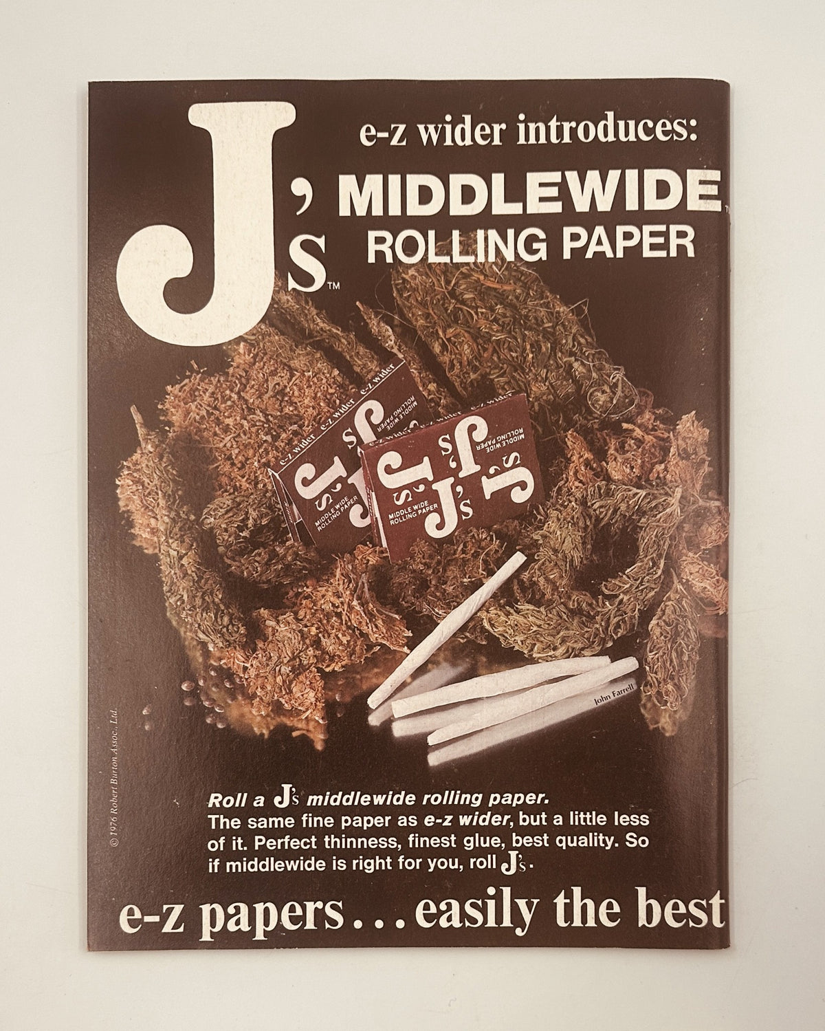J's Middlewide Rolling Paper advertisement showcasing a product designed for rolling cannabis. The ad emphasizes quality and ease of use, promoting a lifestyle associated with smoking.