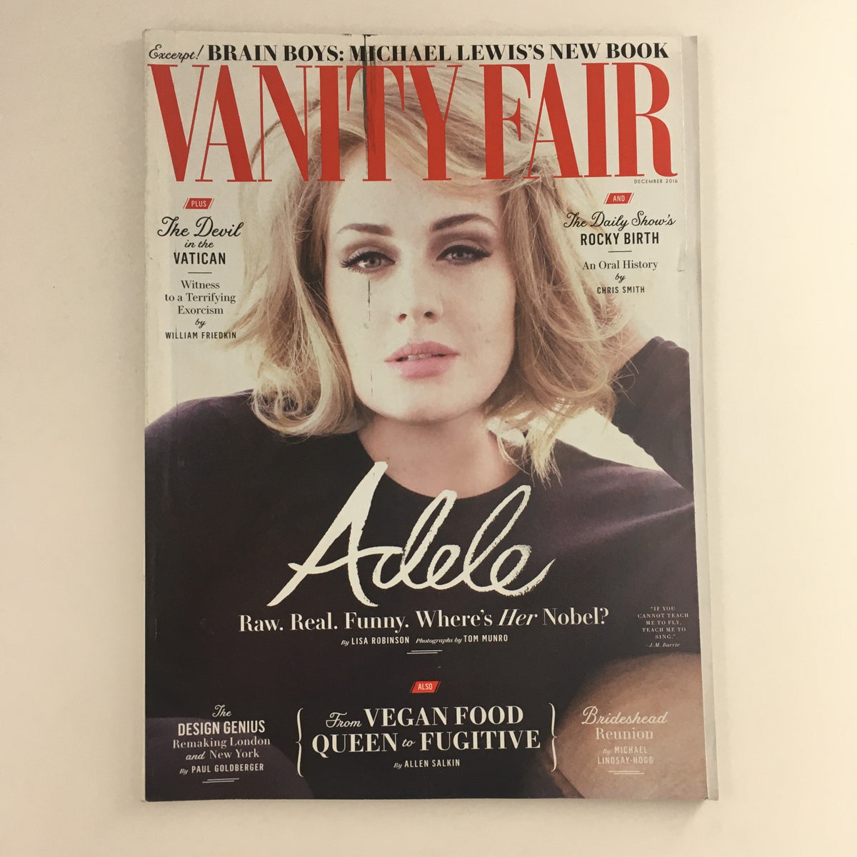 Cover of Vanity Fair Magazine December 2016 featuring singer Adele and Michael Lewis's book. The magazine highlights Adele with the text 'Raw. Real. Funny. Where's Her Nobel?' as part of its captivating cultural commentary.