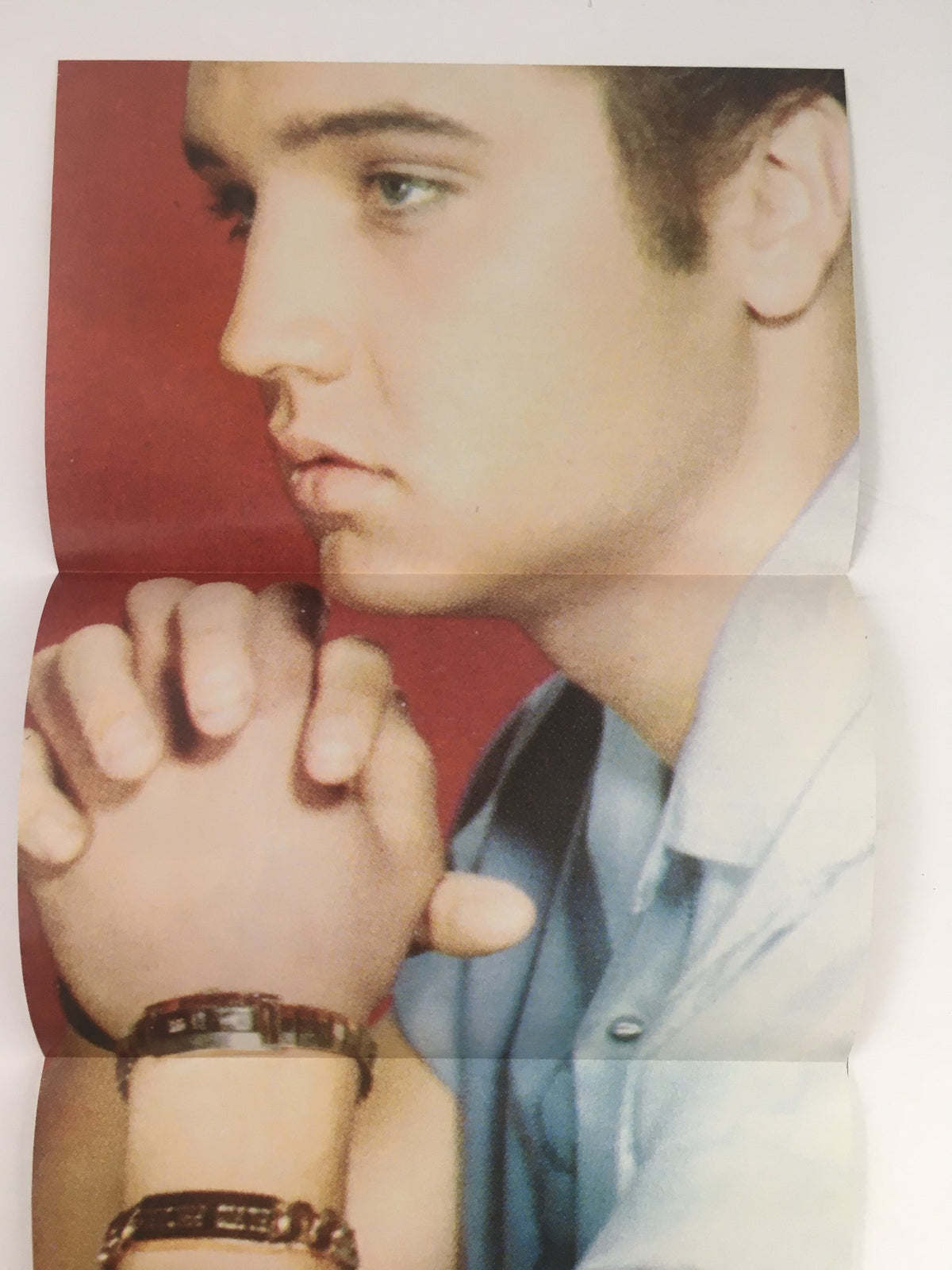 Fold-out poster from Starlog Movie Series Presents 2000 Elvis Presley, showcasing Elvis with a contemplative expression, hands clasped.
