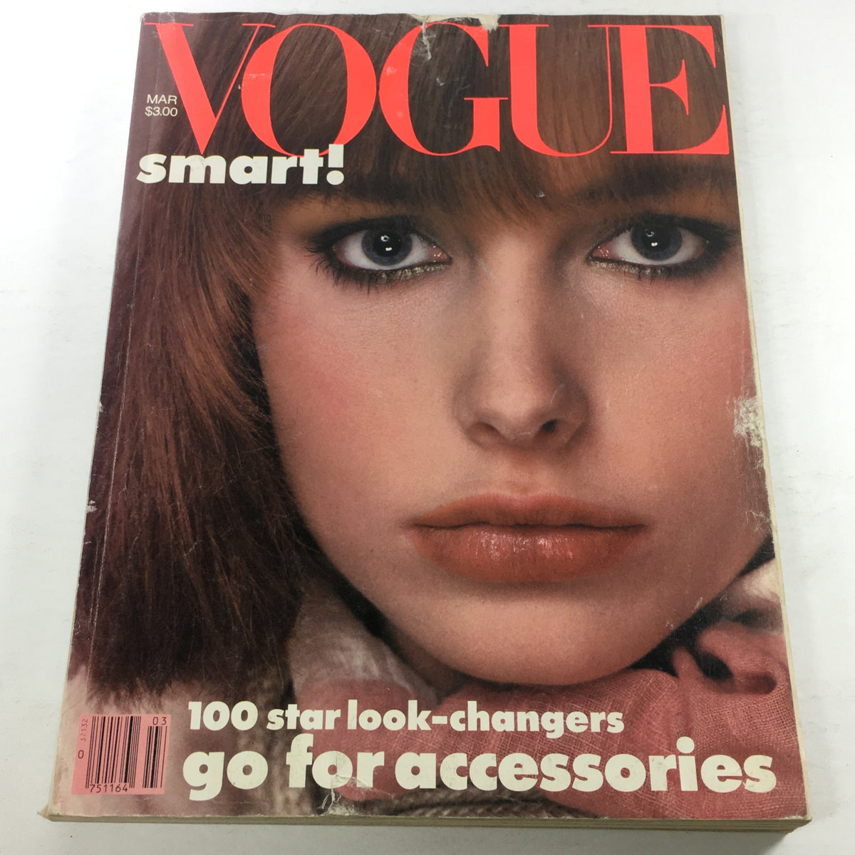 Vogue Magazine March 1983 cover featuring a close-up of a model's face with prominent makeup and striking features, emphasizing fashion aesthetics.