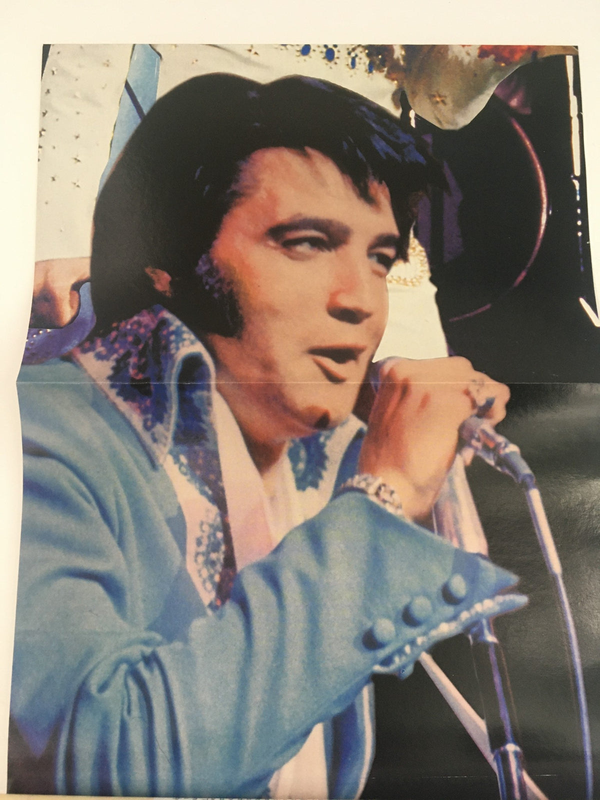 Fold-out poster from Starlog Movie Series Presents 2000 Elvis Presley, depicting Elvis performing on stage in a blue suit.