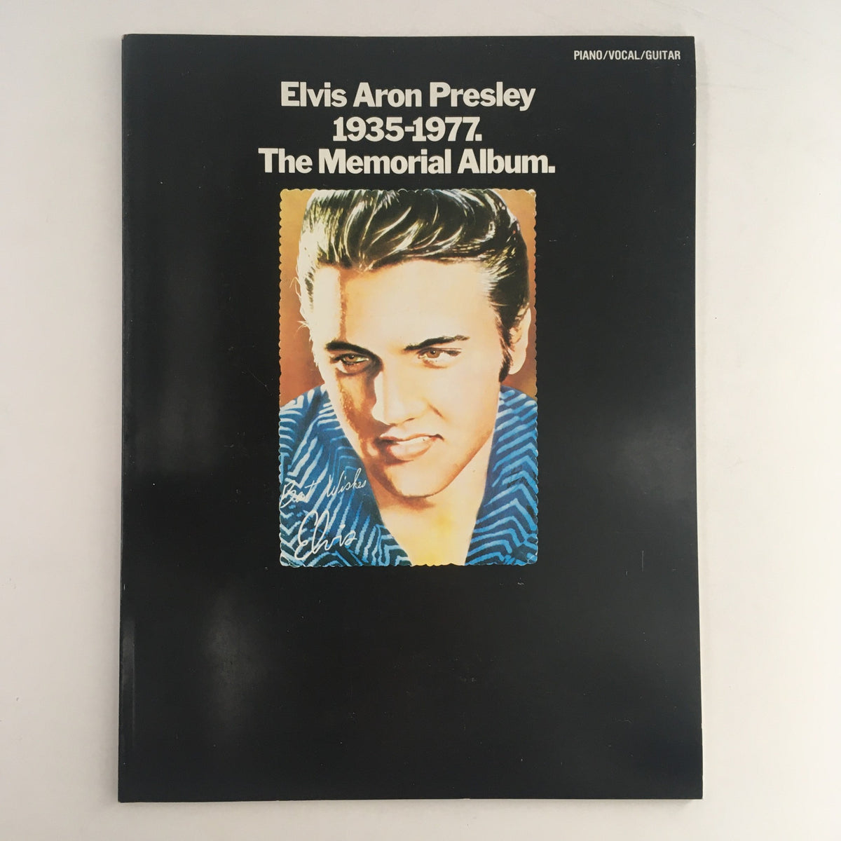 Cover of Elvis Aron Presley 1935-1977 The Memorial Album featuring a portrait of Elvis Presley with vibrant colors against a black background, highlighting the iconic elements of rock and roll history.
