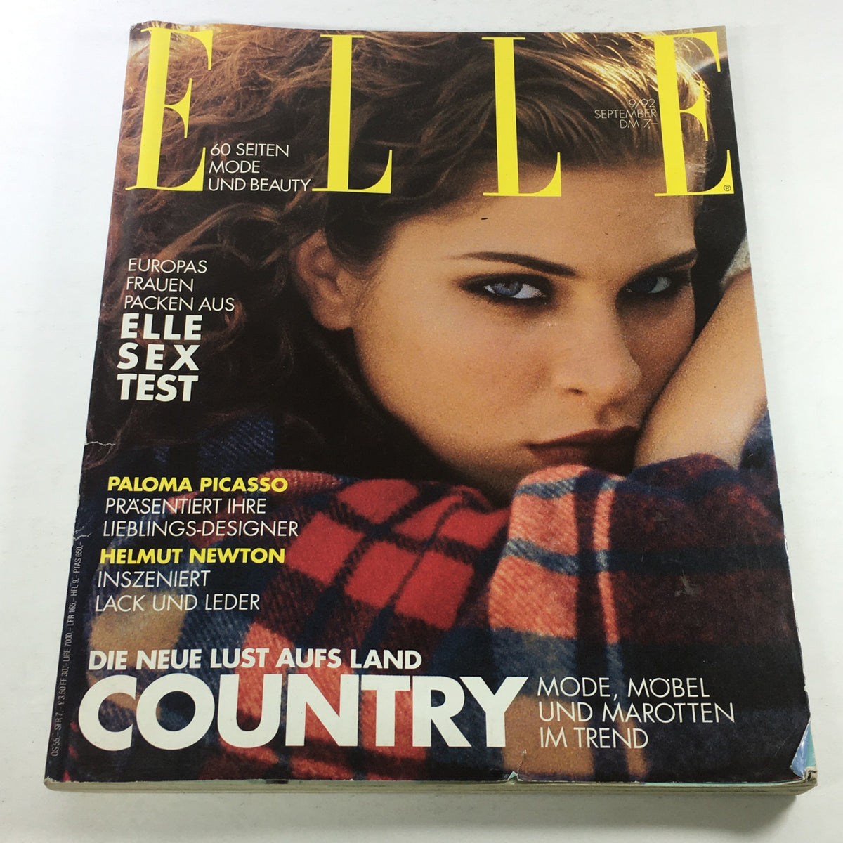Cover of ELLE Magazine Germany September 1992 featuring a model with striking blue eyes and wavy hair, showcasing fashion and beauty themes relevant to the early '90s. This collectible issue highlights articles by renowned designers and photographers.