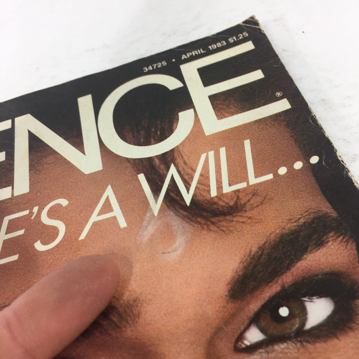 Close-up of the Vintage Essence Magazine April 1983 cover, highlighting the magazine's title and facial details of the featured Black woman.