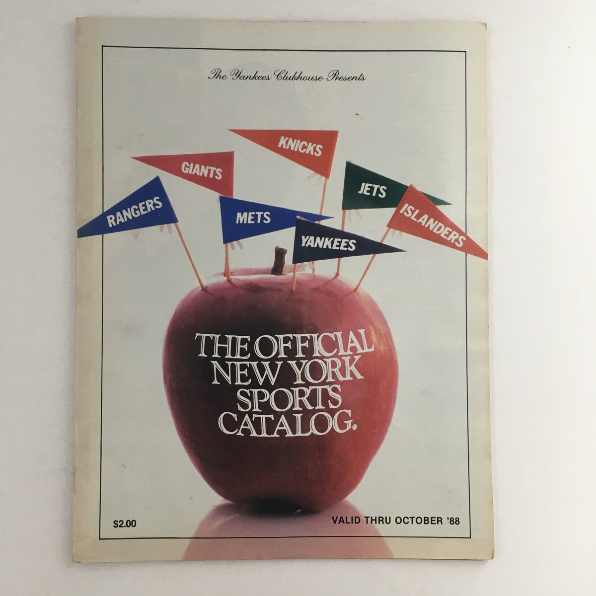 1988 The Yankees Clubhouse Presents The Official New York Sports Catalog cover featuring an apple with sports team flags including Yankees, Mets, Giants, Rangers, Jets, Knicks, and Islanders.