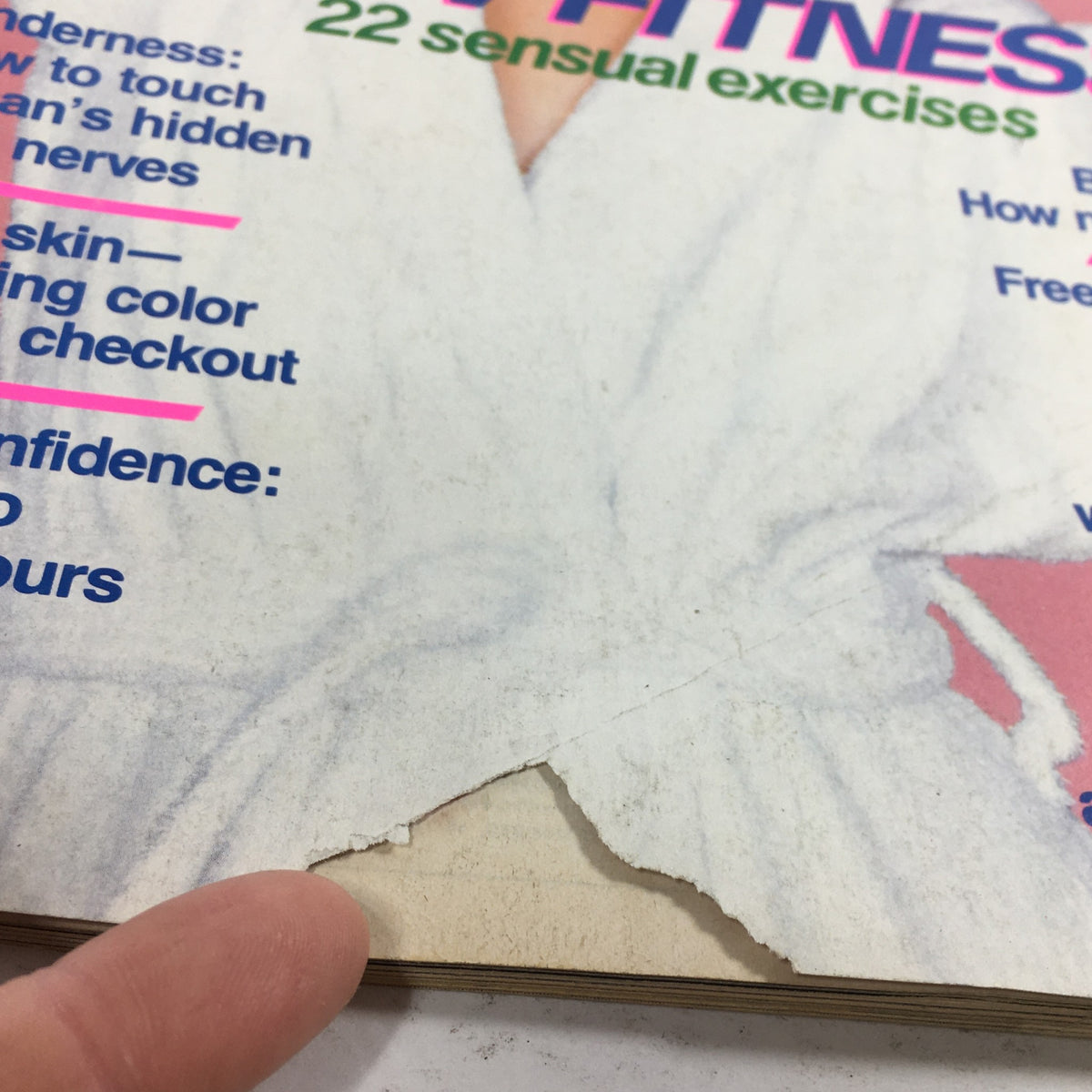 Close-up of the edge of the February 1982 Self Magazine cover, displaying signs of wear, including a slight rip, emphasizing its collectible vintage condition.