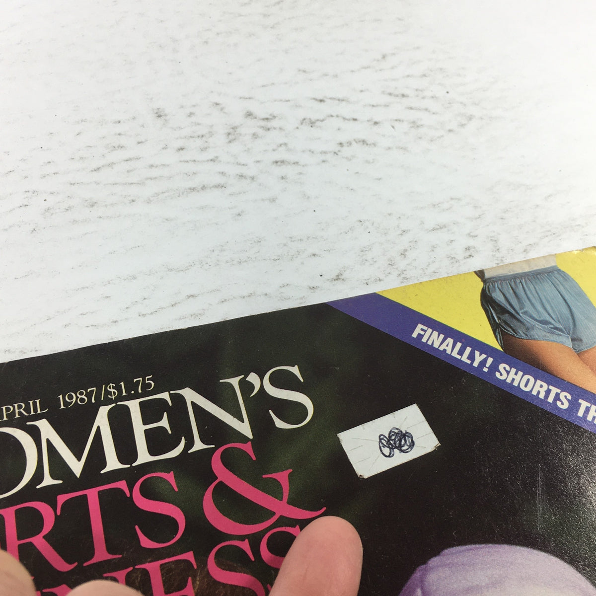 Close-up of the VTG Women's Sports & Fitness Magazine from April 1987, emphasizing a price sticker and the tagline about shorts that fit.
