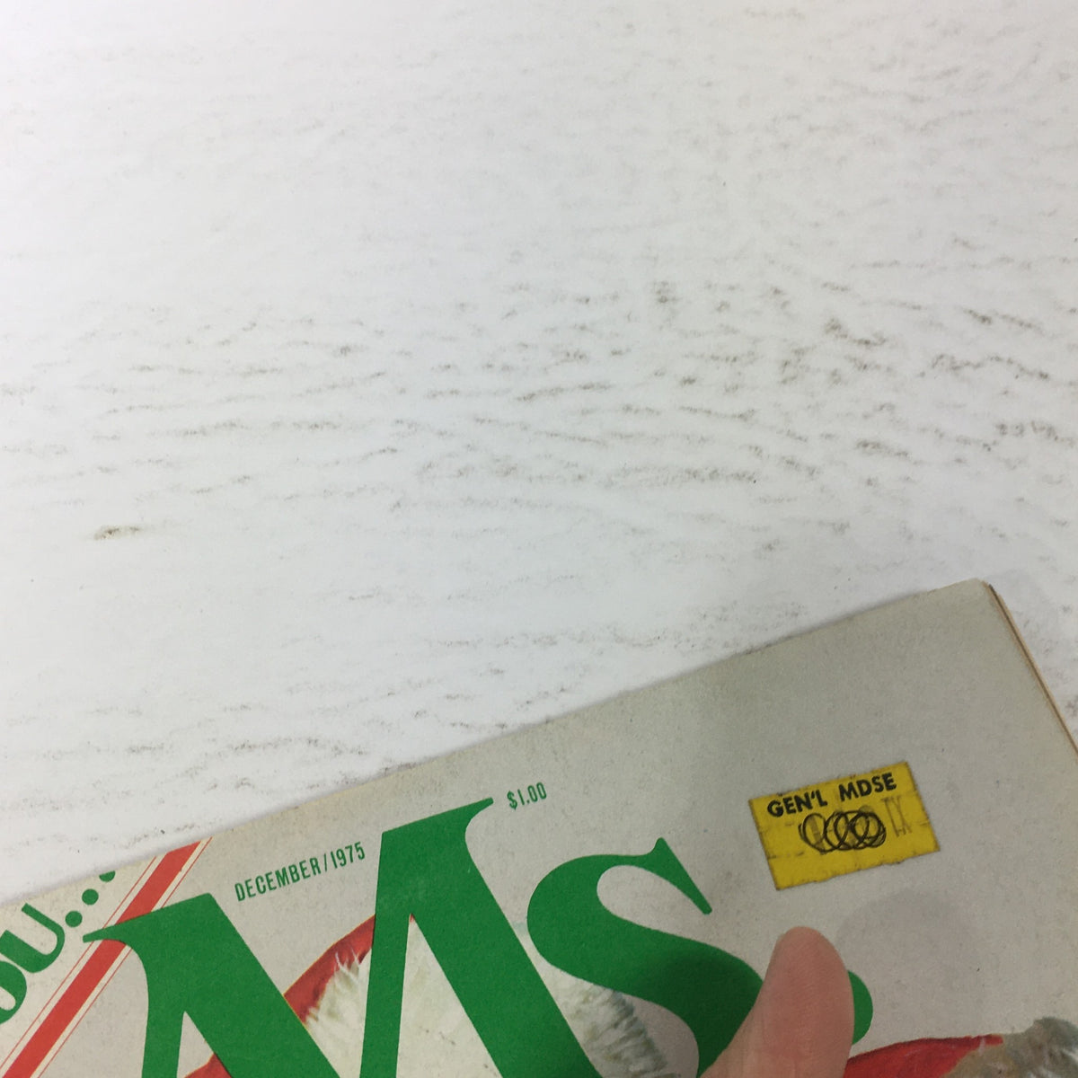 Close-up view of the vintage MS. Magazine cover from December 1975, highlighting the price sticker and publication details, emphasizing its collectible nature and historical significance.