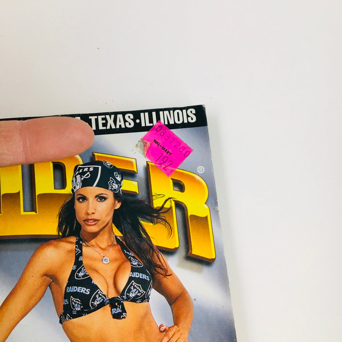Close-up of the price sticker on the cover of LowRider Magazine October 2000, emphasizing its collectible nature and historical significance in the lowrider community.
