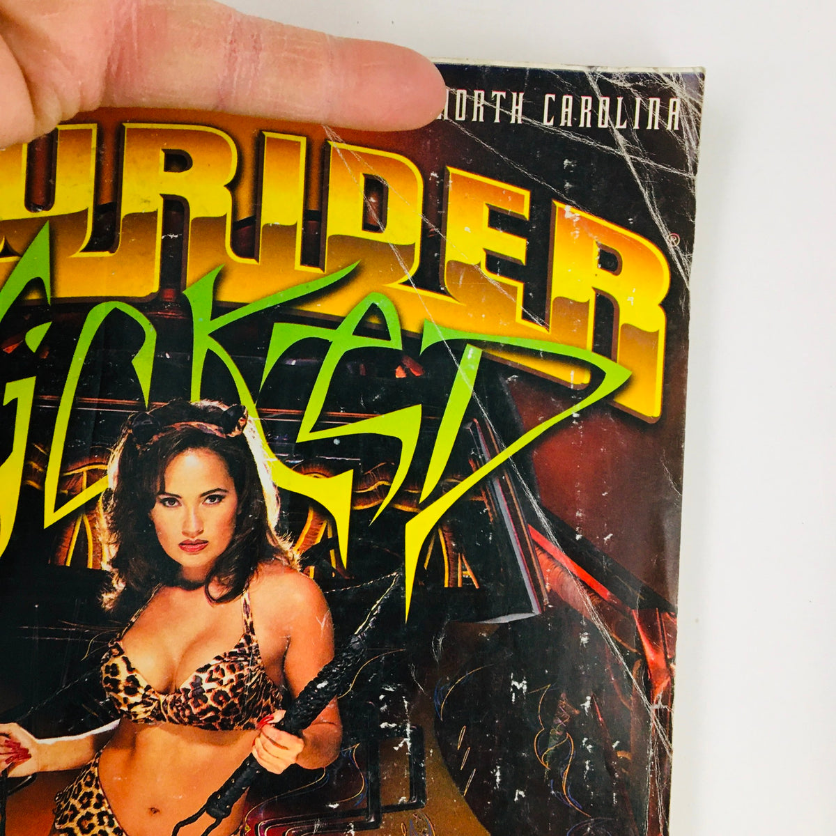 Close-up detail of the LowRider Magazine October 1999 cover showcasing the vivid artwork and model, emphasizing the 'Wicked' theme of the issue.