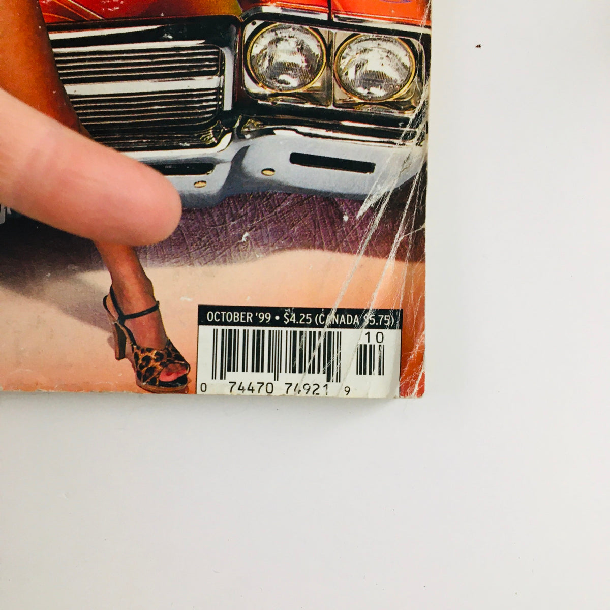 Bottom corner of the LowRider Magazine October 1999 cover displaying the price and publication month, illustrating its collectible status.