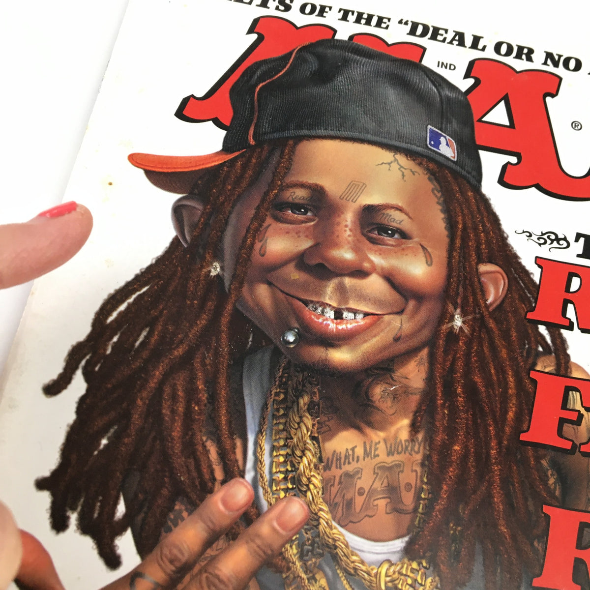 Close-up of the cover design of Mad Magazine December 2008 #496, highlighting Lil Wayne's cartoon likeness and details such as gold accessories and facial expression.
