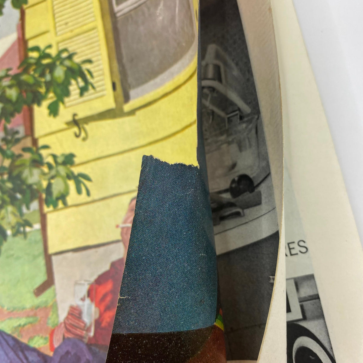 Close-up image showing the edge of the cover of Saturday Evening Post Magazine from April 12, 1958, highlighting minor wear and small rips on the cover art by Dick Sargent.