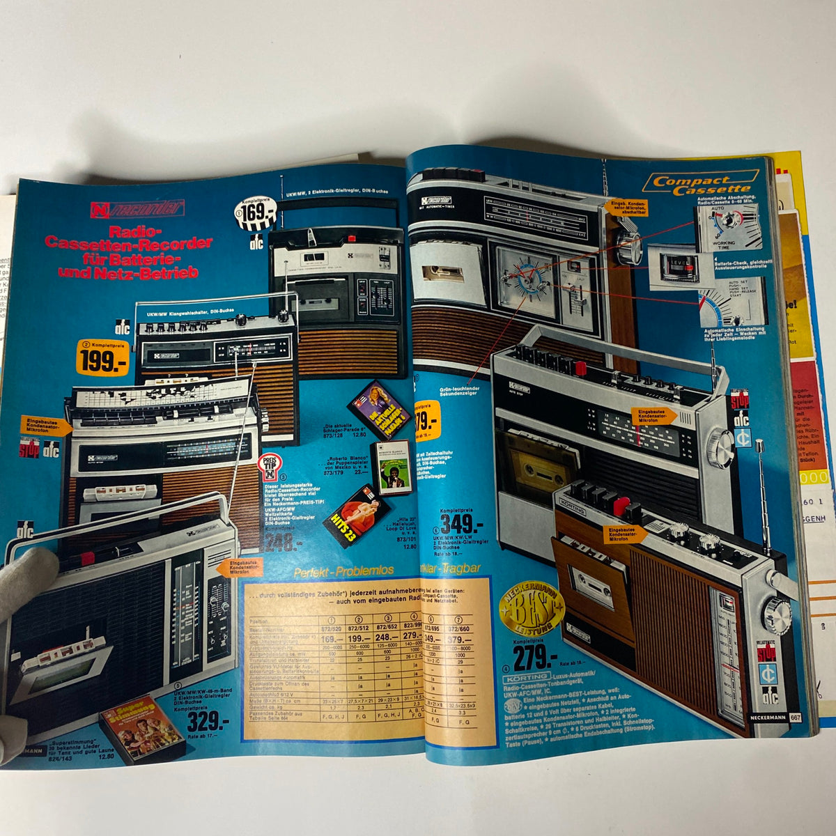 1973-1974 Neckermann Winter Catalog showcasing various radio cassette recorders with detailed pricing and features on a vibrant blue background.