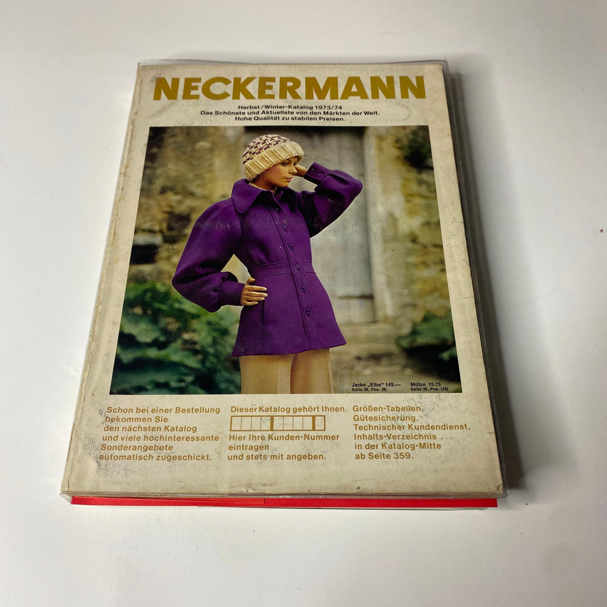 1973-1974 Neckermann Winter Catalog cover depicting a model wearing a stylish purple jacket, highlighting winter fashion trends of the era.