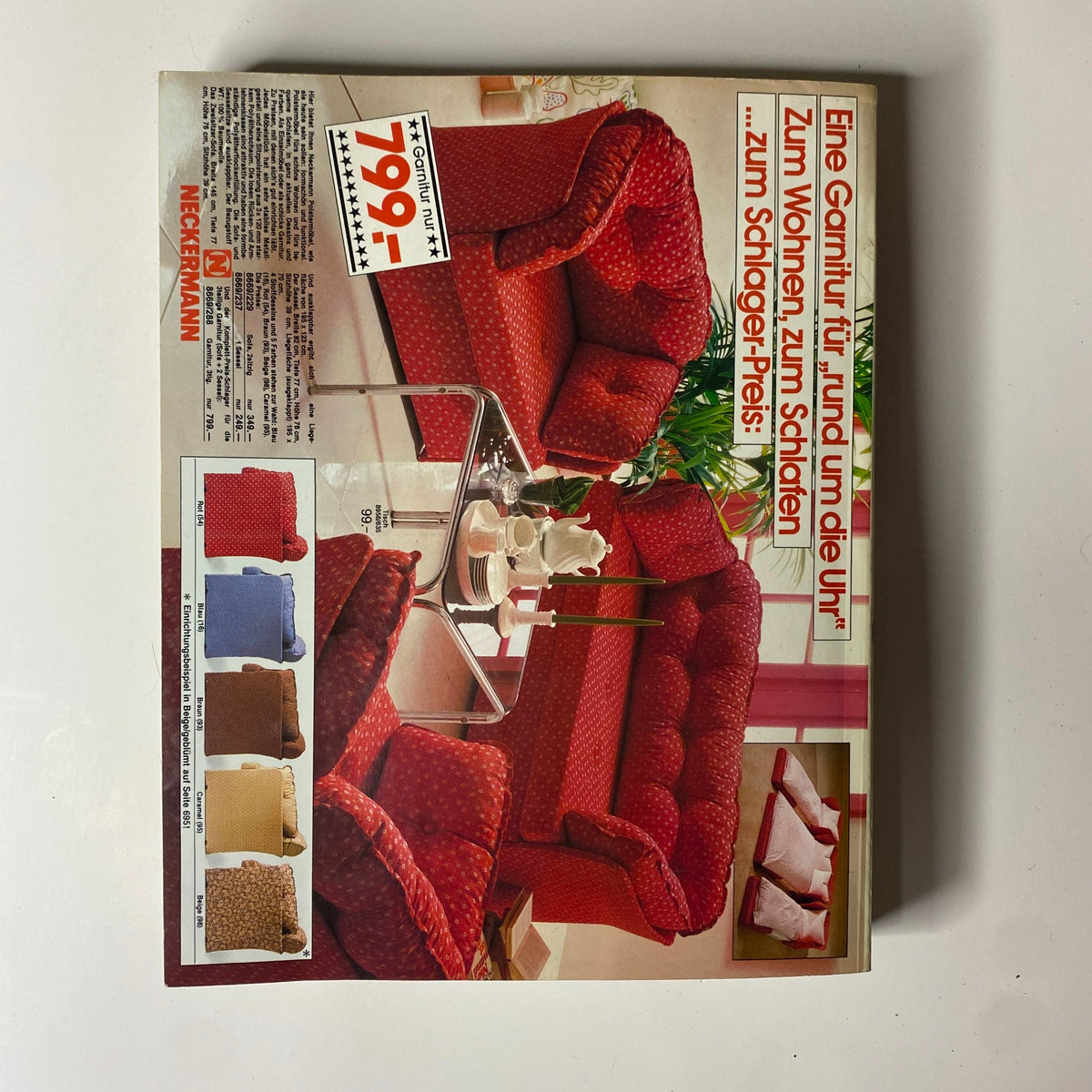 1982 Neckermann Summer Catalog showcasing a vibrant red living room set with polka dot upholstery, alongside swatches in various colors including blue, brown, yellow, and patterned fabric. Featured price of 799 marks, illustrating retro furniture styles and design trends from early 1980s Germany.