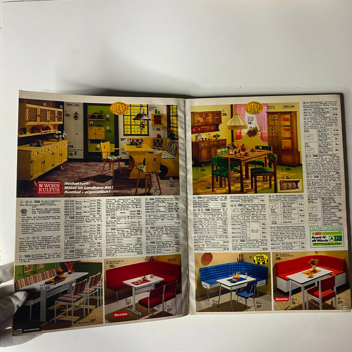 Interior page from the 1974-1975 Neckermann Winter Catalog showcasing vintage furniture designs including kitchen and dining room setups with various styles and colors.