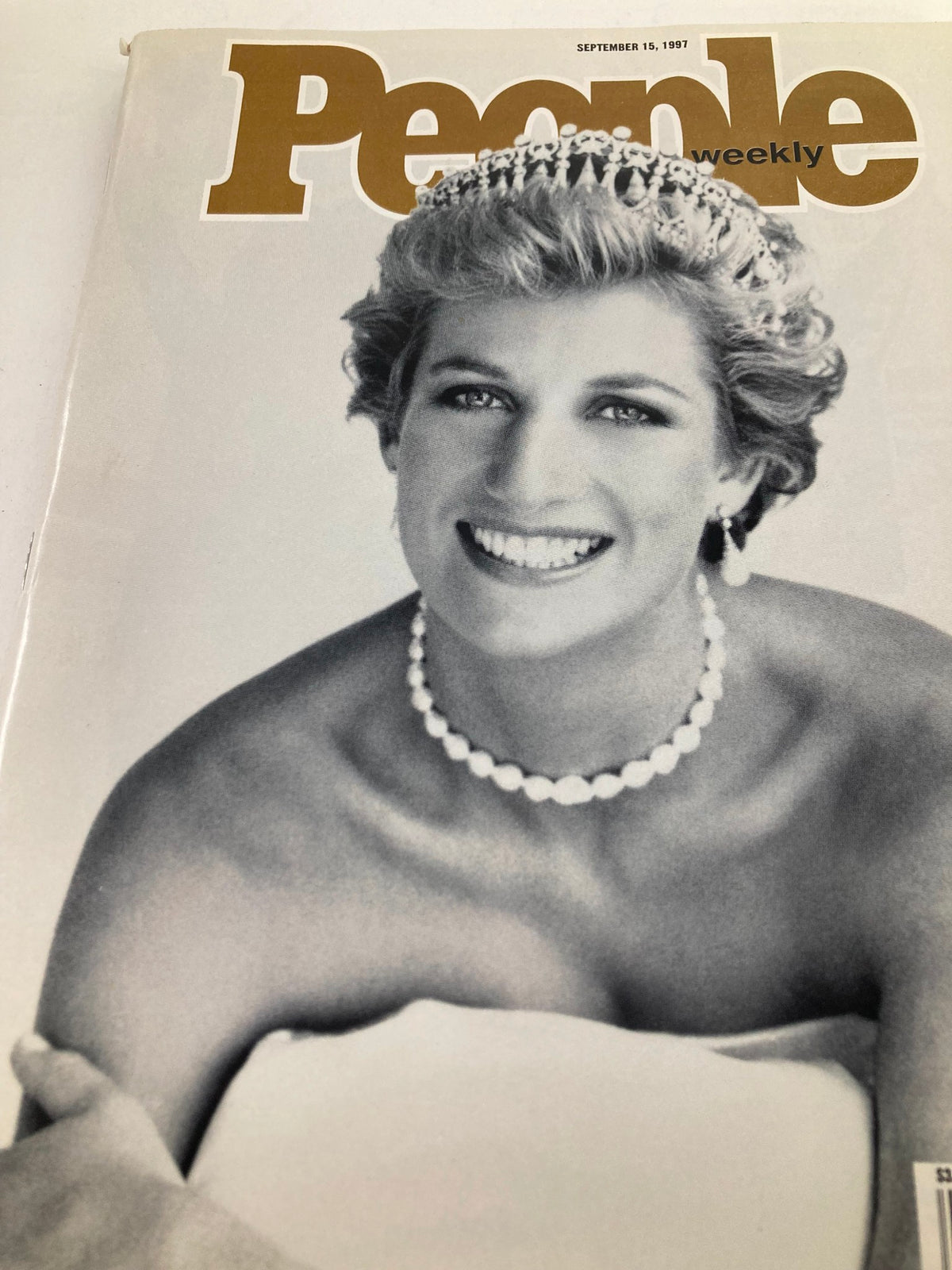Close-up of the cover of People Weekly Magazine from September 15, 1997, highlighting Princess Diana, smiling elegantly with a tiara and pearls.