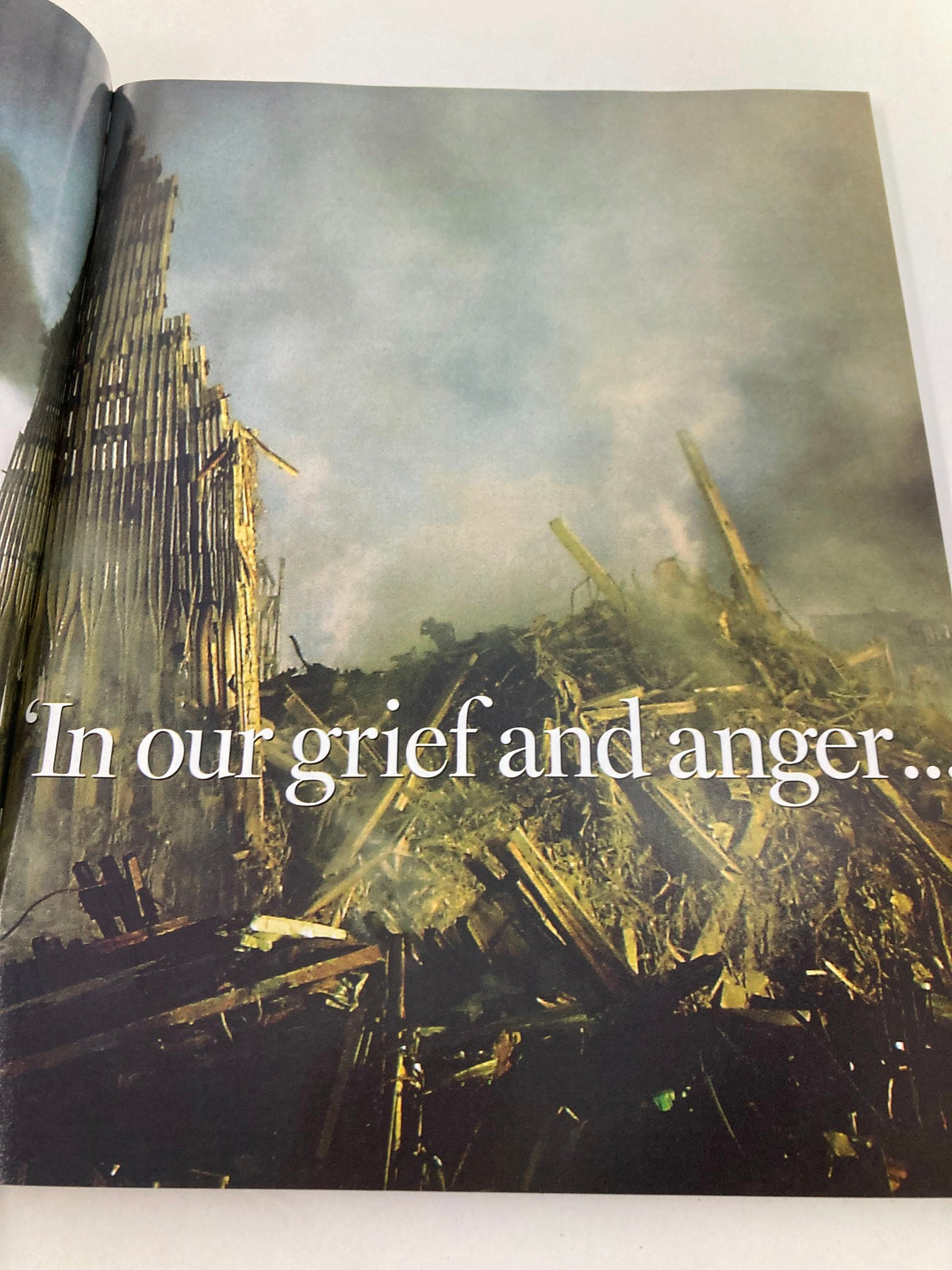 Inside page of Newsweek Magazine Fall 2001 The Spirit of America, displaying a poignant image of the aftermath of the September 11 attacks with the text 'In our grief and anger...'.