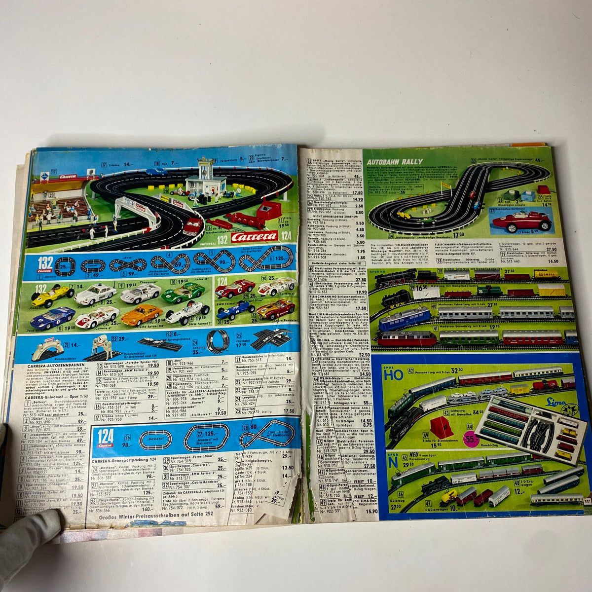 1973 Neckermann Summer Catalog page displaying a colorful collection of Carrera slot racing tracks and toy cars, illustrating popular toys during the 1970s.