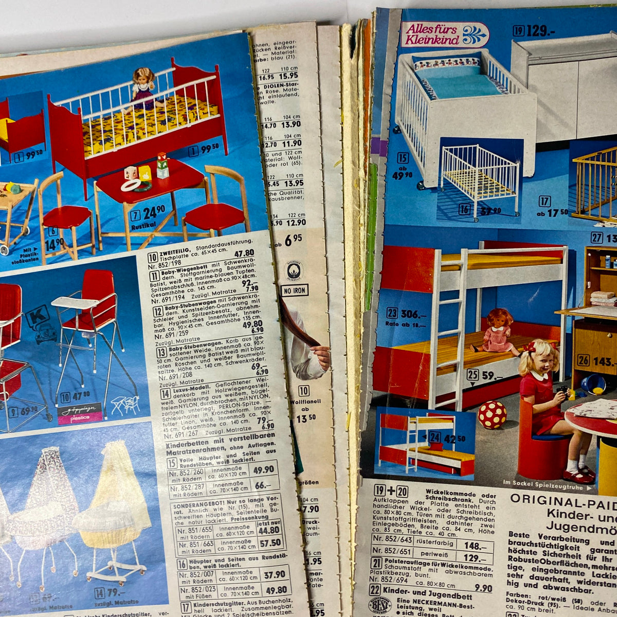 Detailed page from the 1973 Neckermann Summer Catalog showcasing children's furniture and toys, including a crib, play furniture, and other home goods.