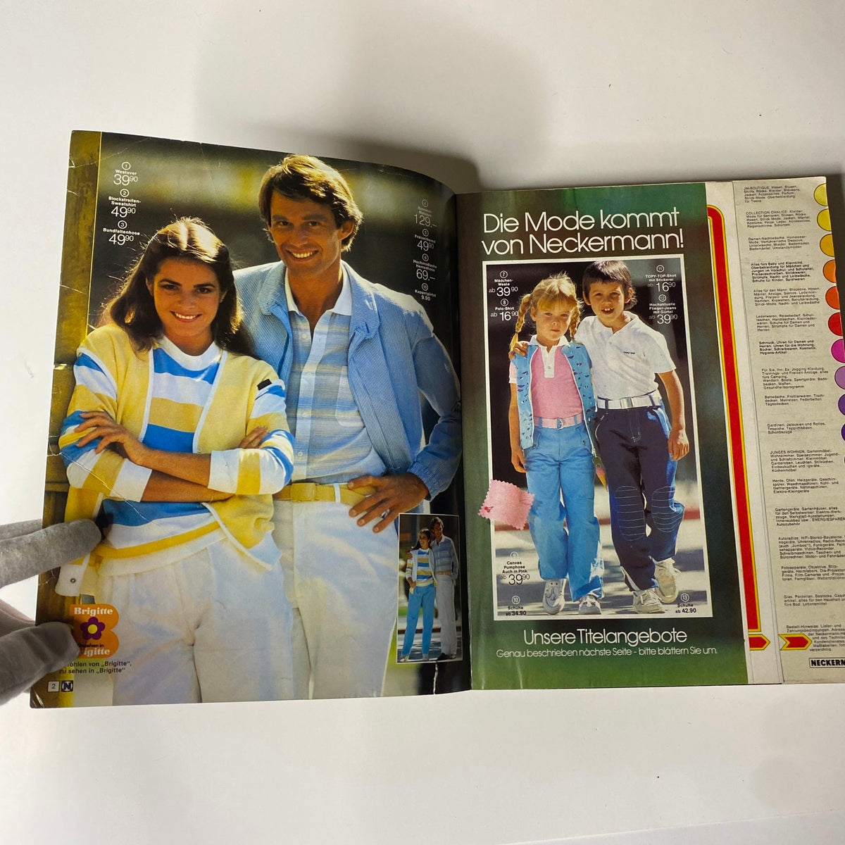 Inside view of the 1981 Neckermann Summer Catalog displaying a couple in stylish summer clothing along with children modeling trendy outfits. Captures the essence of early 1980s fashion.