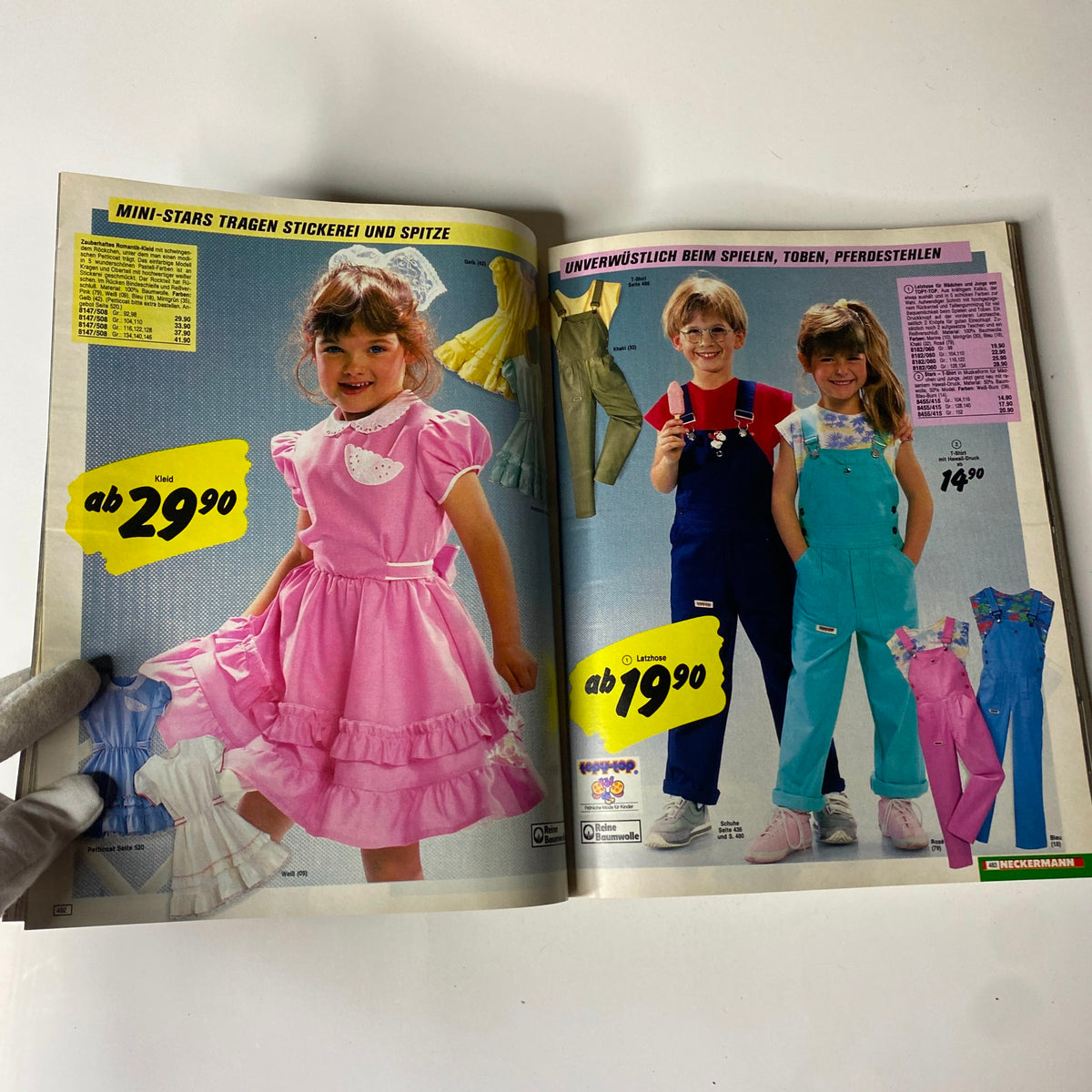 Page from the 1985 Neckermann Summer Catalog featuring children's summer outfits, including dresses and overalls with vibrant colors.