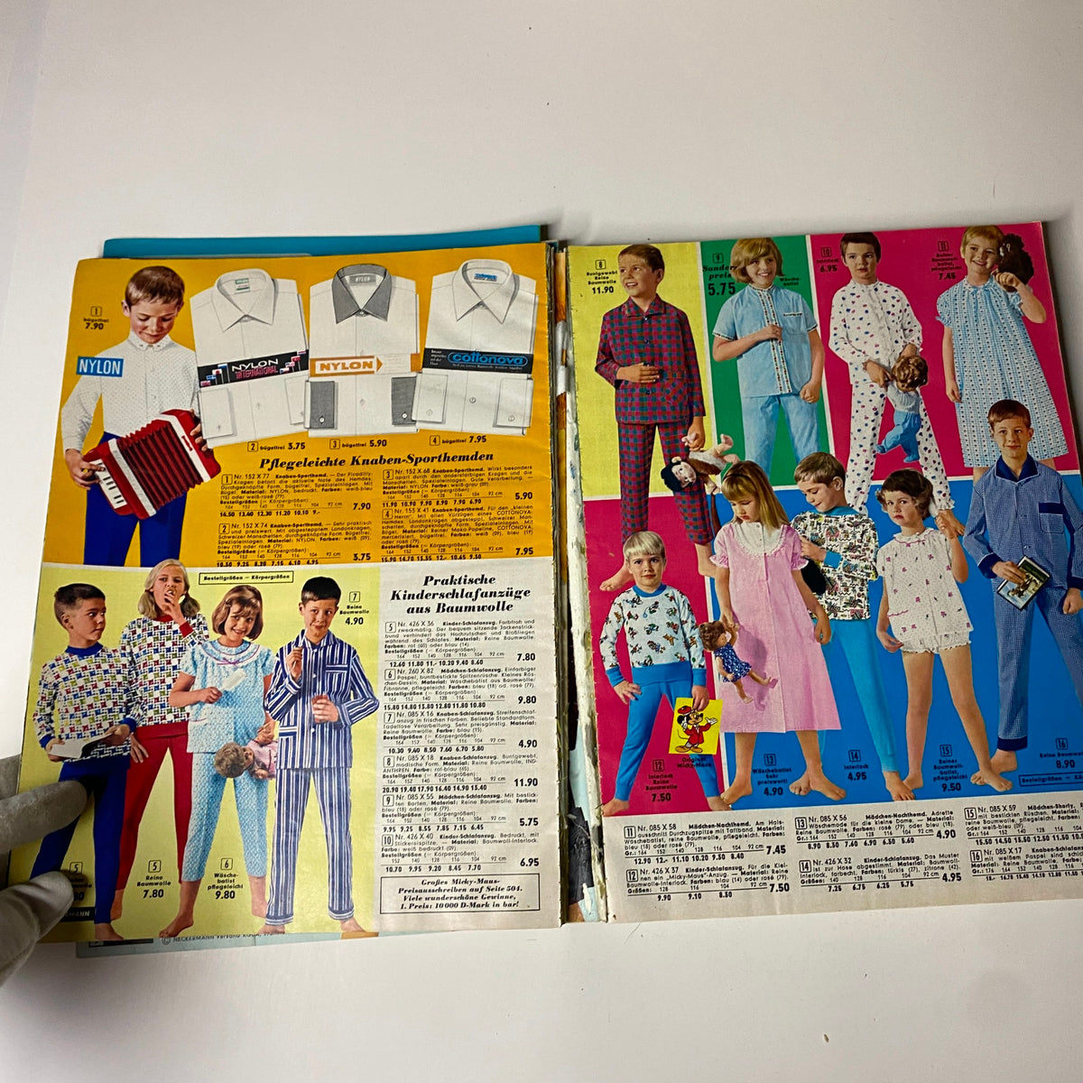 1966 Neckermann Summer Catalog displaying children's clothing, featuring boys and girls in playful outfits and pajamas on a brightly colored page.