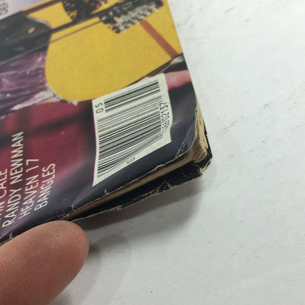 Close-up view of the edge of the May 1983 issue of VTG Creem Magazine featuring Prince, Bob Seger, Phil Collins, and Def Leppard, showcasing natural wear and slight damage, perfect for collectors.