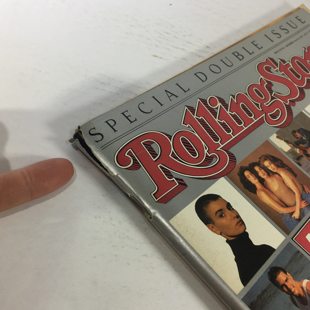 Close-up of the corner of the Rolling Stone Magazine December 1990 featuring Tom Cruise, showcasing its vintage design and signs of wear.