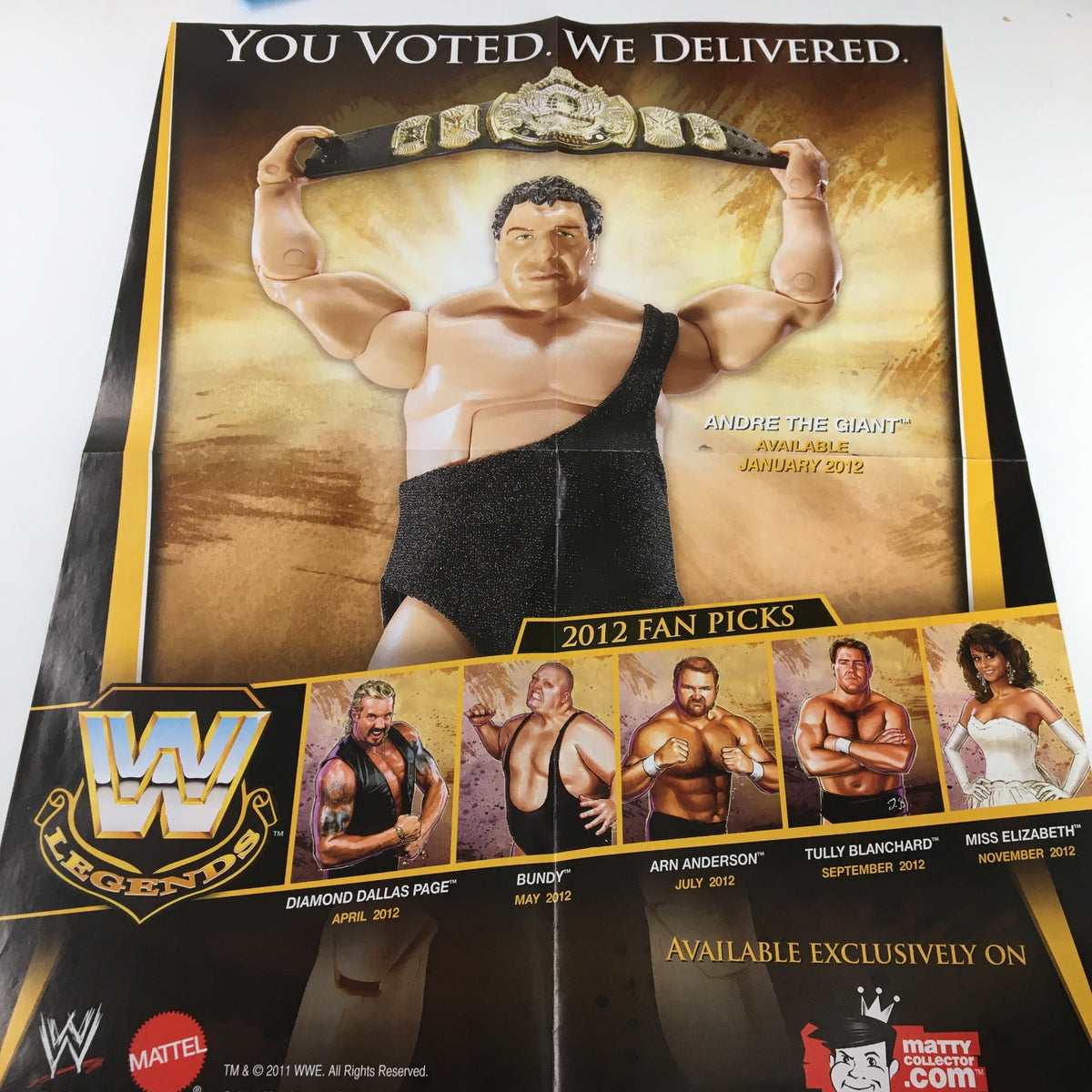 WWE Magazine December 2011 includes a promotional poster for the 2012 Fan Picks, featuring figures of wrestling legends like Andre the Giant, enhancing its appeal for collectors and wrestling enthusiasts.