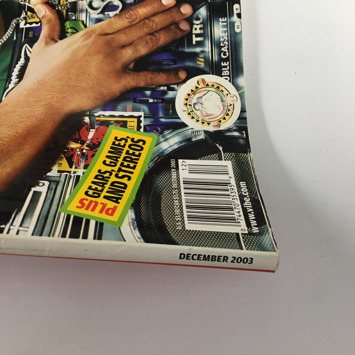 Side view of VIBE Magazine December 2003 showing the magazine spine with a price label and barcodes, reflecting its vintage condition. This issue features Sean Paul and Biz Markie.