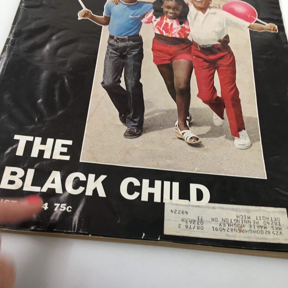 Close-up of the cover of VTG Ebony Magazine August 1974 The Black Child Special Issue showcasing the title and children smiling with a colorful background.