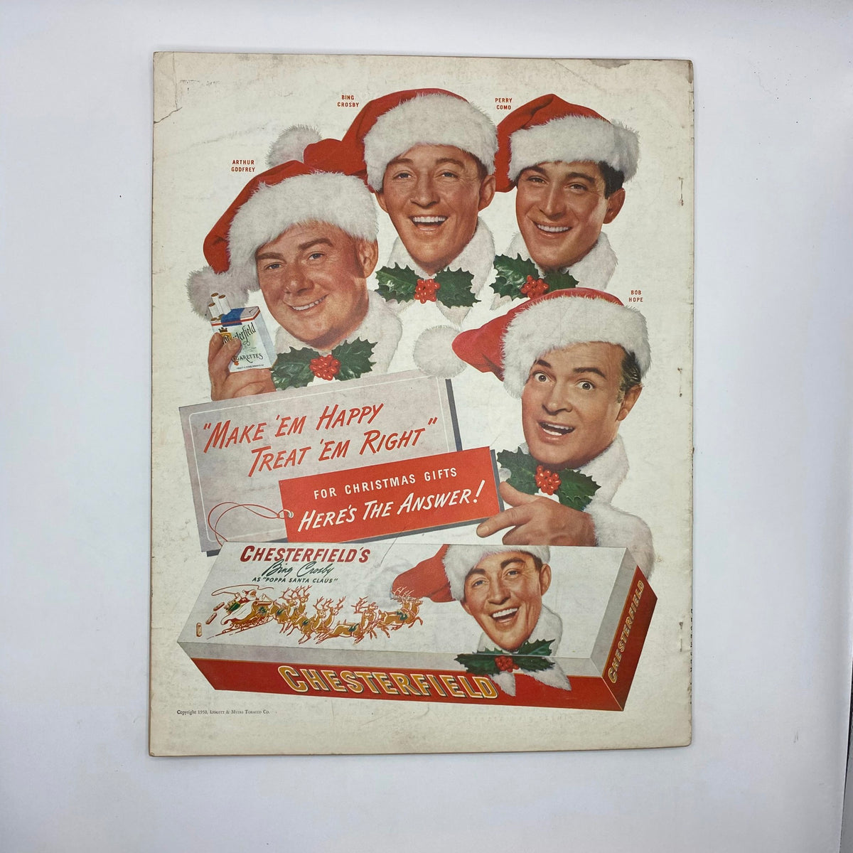 Back cover of McCall's Magazine December 1950 featuring a festive advertisement with famous personalities in holiday attire promoting Chesterfield's gifts for Christmas.
