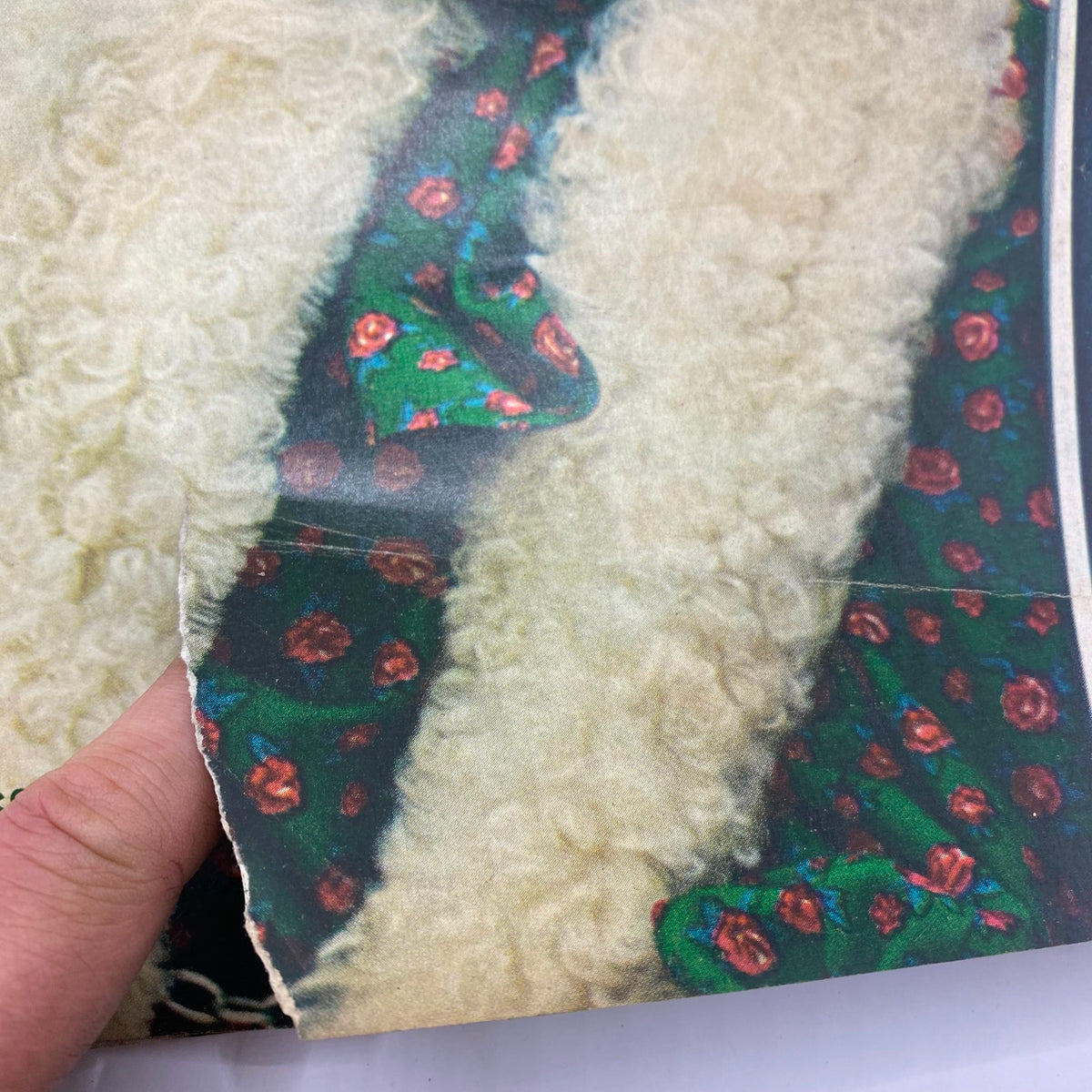 Close-up detail of the cover of VTG McCall's Magazine November 1968, highlighting the textured fabric and floral design of the model's outfit.
