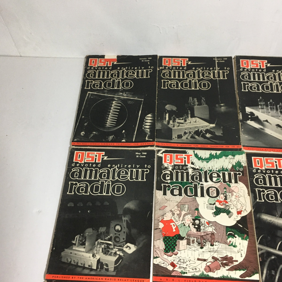 Lot of 12 Complete January to December 1948 QST Amateur Radio magazines featuring covers with technical illustrations and festive designs.