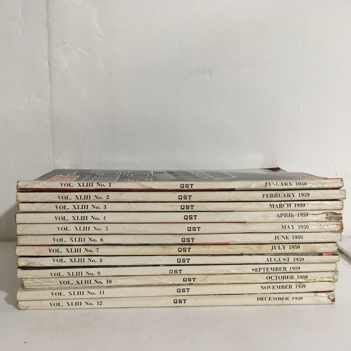 Lot of 12 Complete January to December 1959 QST Amateur Radio - displaying the spines of all 12 issues with publication months listed.