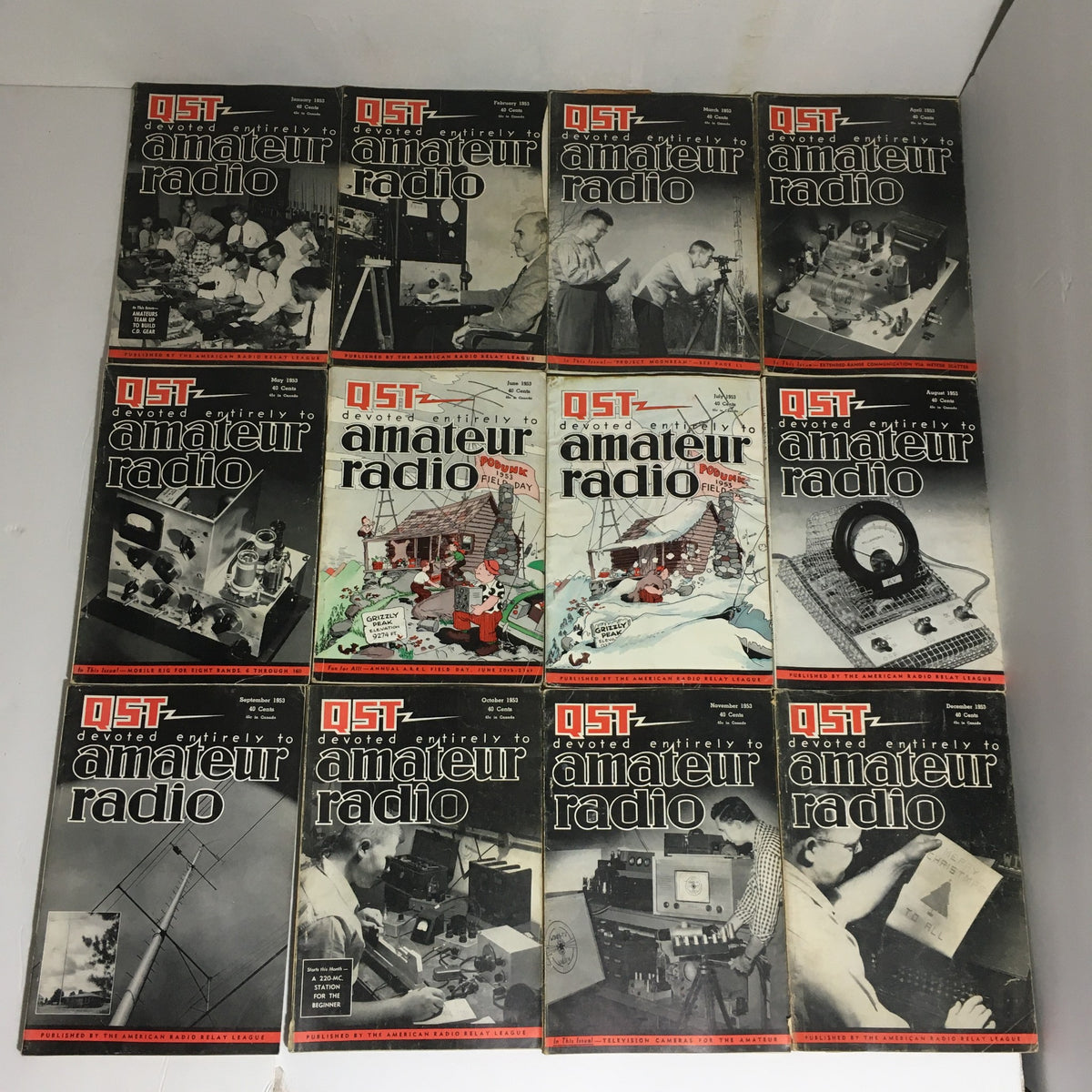 Lot of 12 Complete January to December 1953 QST Amateur Radio magazines displayed together, showcasing the covers featuring historical content related to amateur radio.