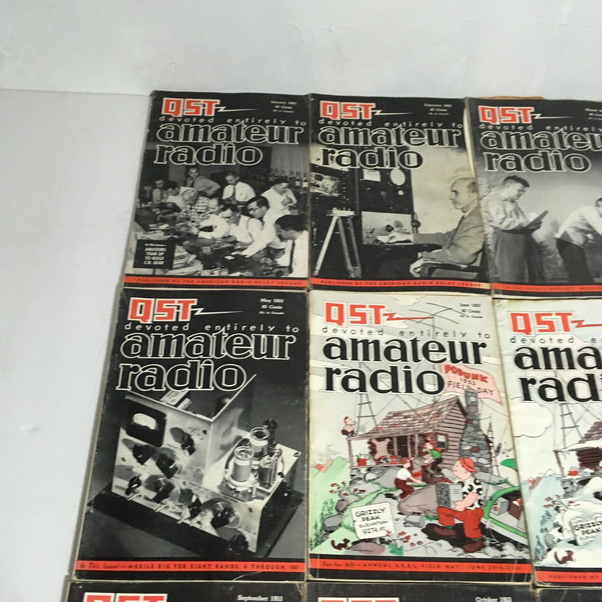Lot of 12 Complete January to December 1953 QST Amateur Radio magazines arranged in two rows, illustrating various editions with vintage designs and images related to radio technology.