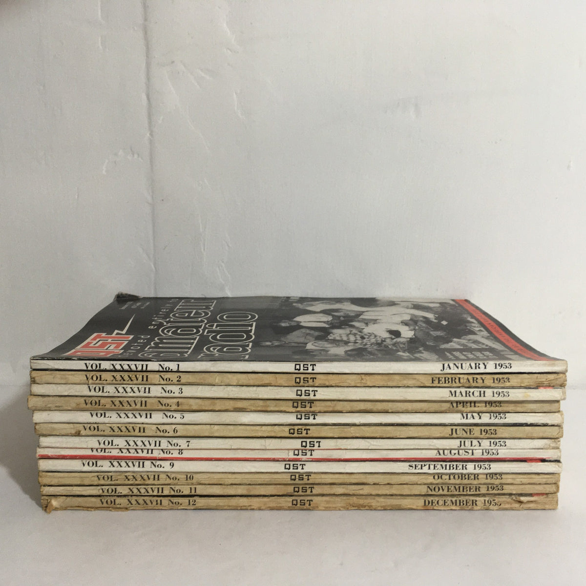 Lot of 12 Complete January to December 1953 QST Amateur Radio magazines stacked, showing the spine labels and month of each issue.