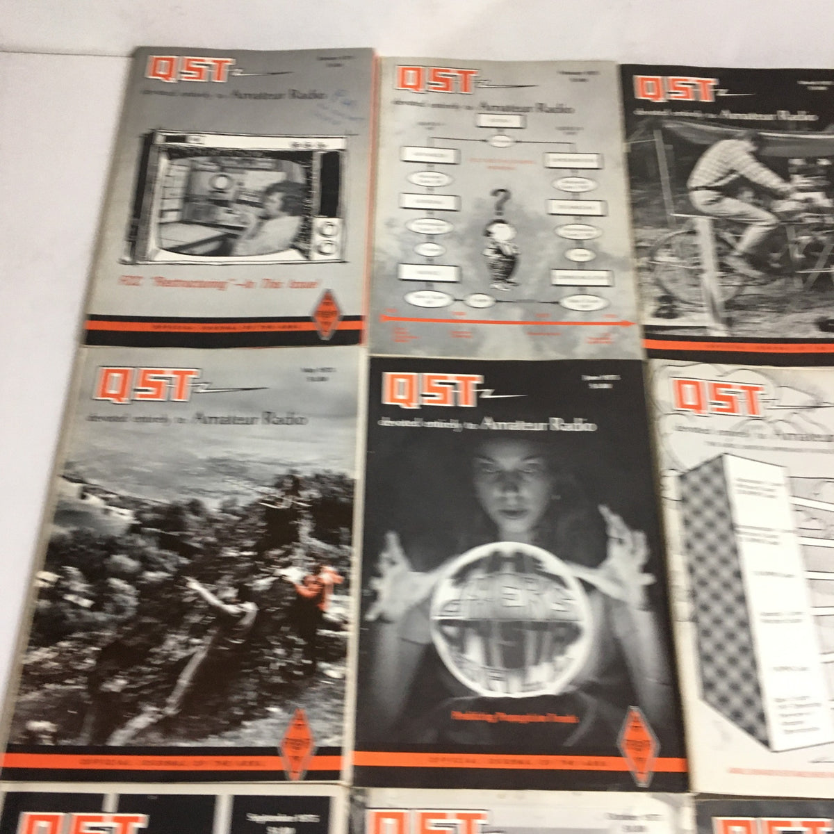 Lot of 12 Complete January to December 1975 QST Amateur Radio magazines arranged, highlighting several covers with innovative amateur radio technologies.