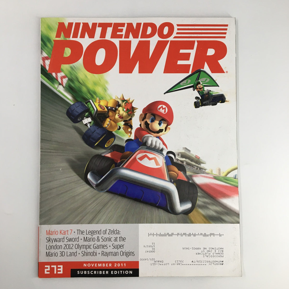 Nintendo Power Magazine Issue 273 from November 2011 showcasing Mario Kart 7 on the cover with Mario and characters racing. Features highlights of The Legend of Zelda, Skyward Sword, and other games.