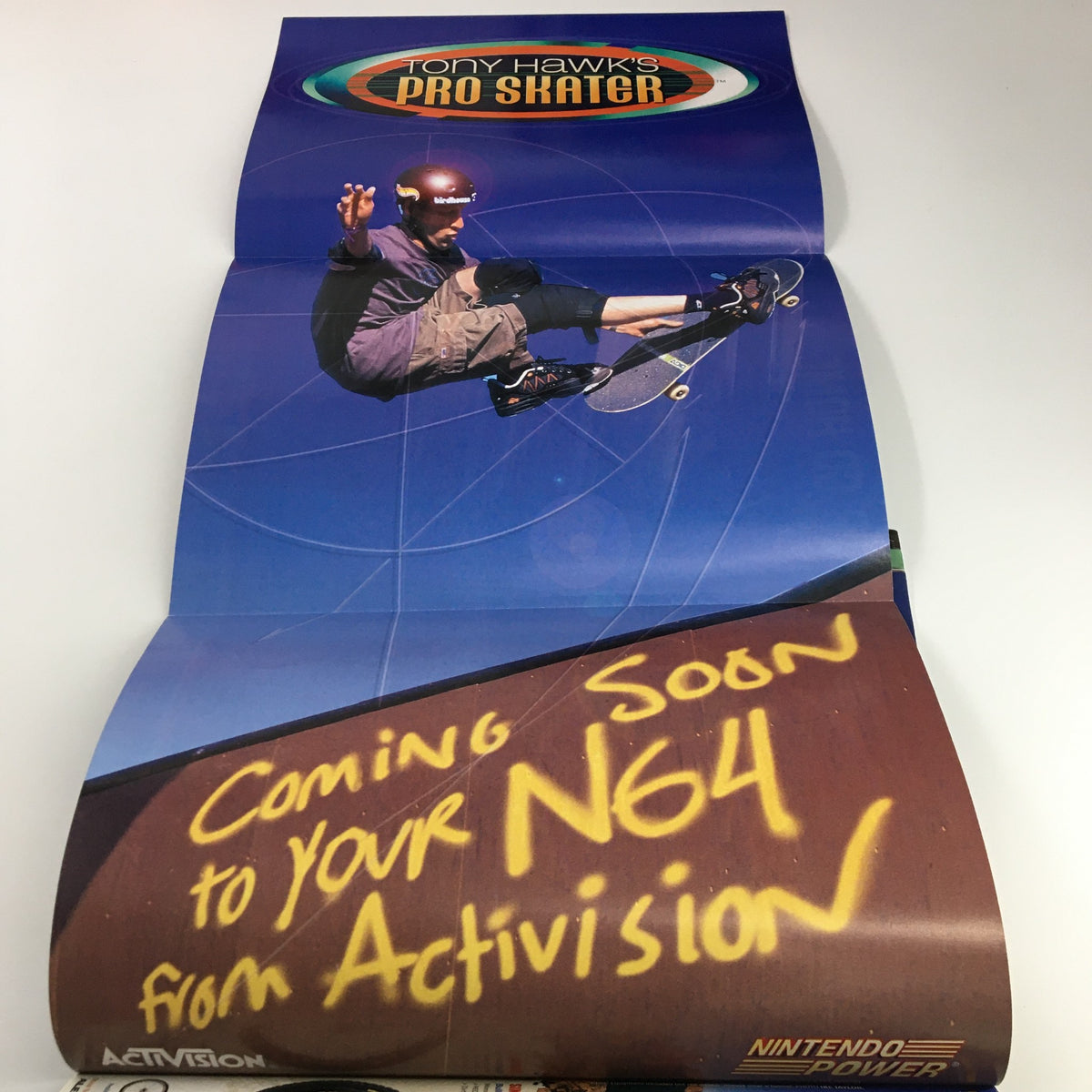 Nintendo Power Magazine Vol. 129 February 2000 poster featuring Tony Hawk performing a skateboarding trick with the text 'Coming Soon to your N64 from Activision.'