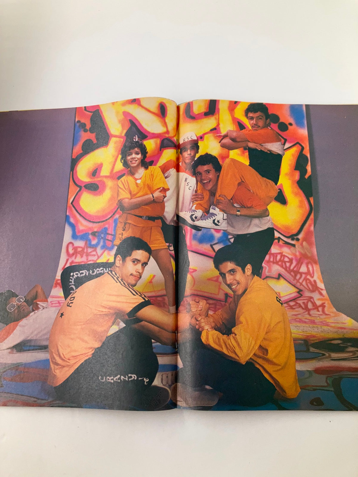 Inside page of Lookin Magazine November 12, 1983, displaying members of the Rock Steady Crew in a lively pose against a colorful graffiti backdrop.