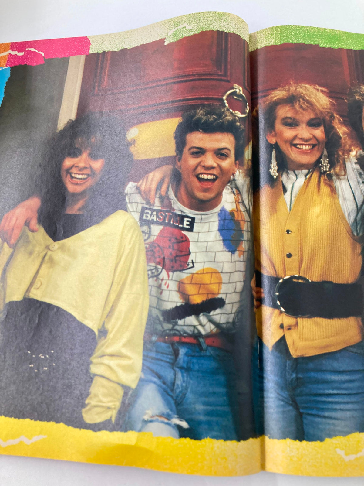 A vibrant double-page spread from VTG Lookin Magazine 1988 #39 showcasing three friends smiling cheerfully, embodying the spirit of late 1980s fashion and culture.